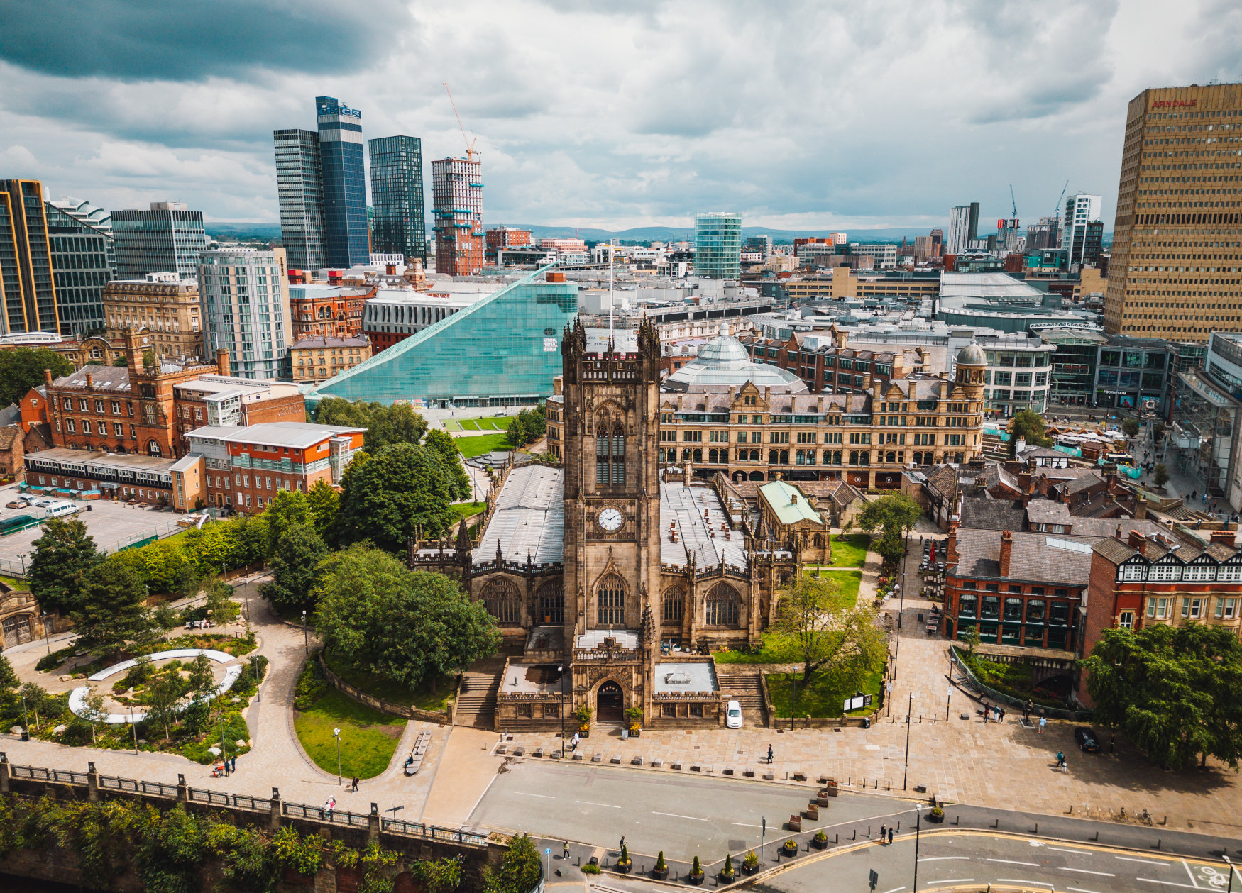 Skyline view of Manchester with Manchester Cathedral in front