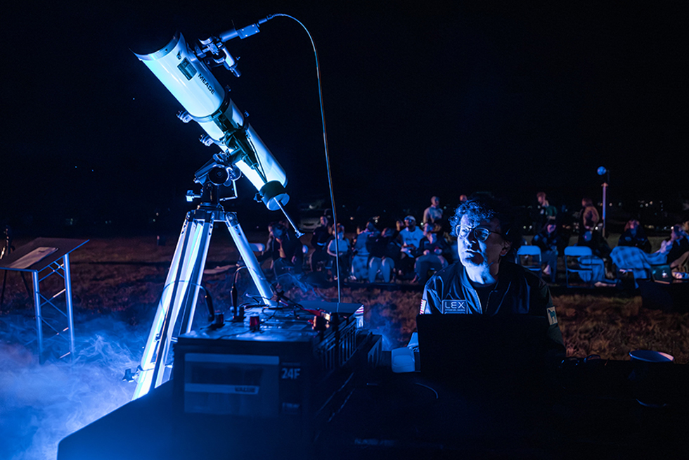 A man observing through a telescope, exploring the wonders of the universe.