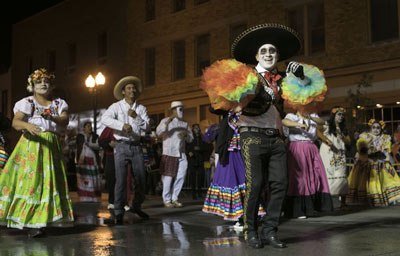 Costumed attendees participate in the Halloween Thriller parade.