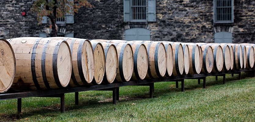 Line of bourbon barrels on a track