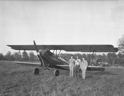 A historic black and white photo of the first plane landing at Halley Field.