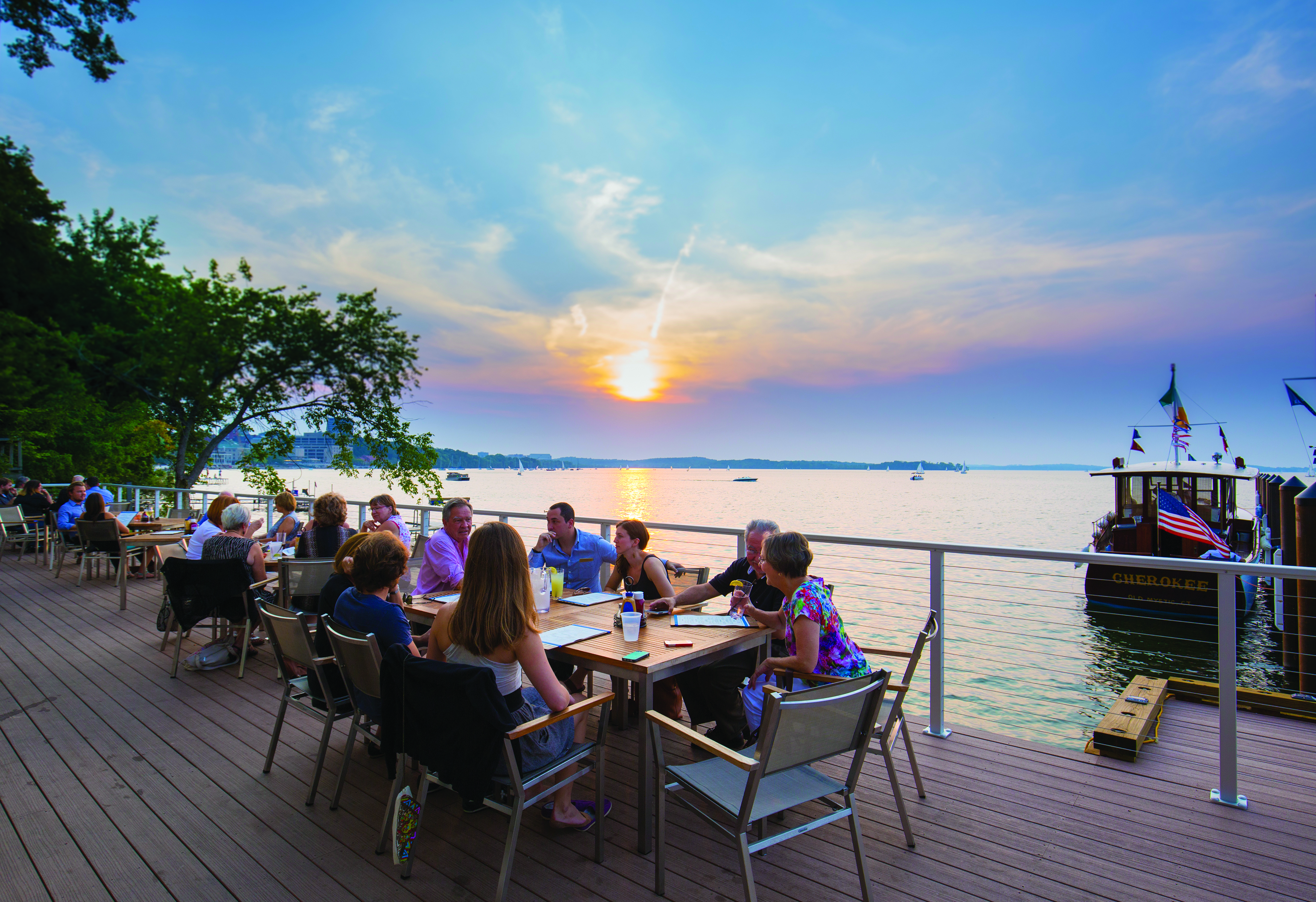 People dining on an outdoor patio at The Edgewater