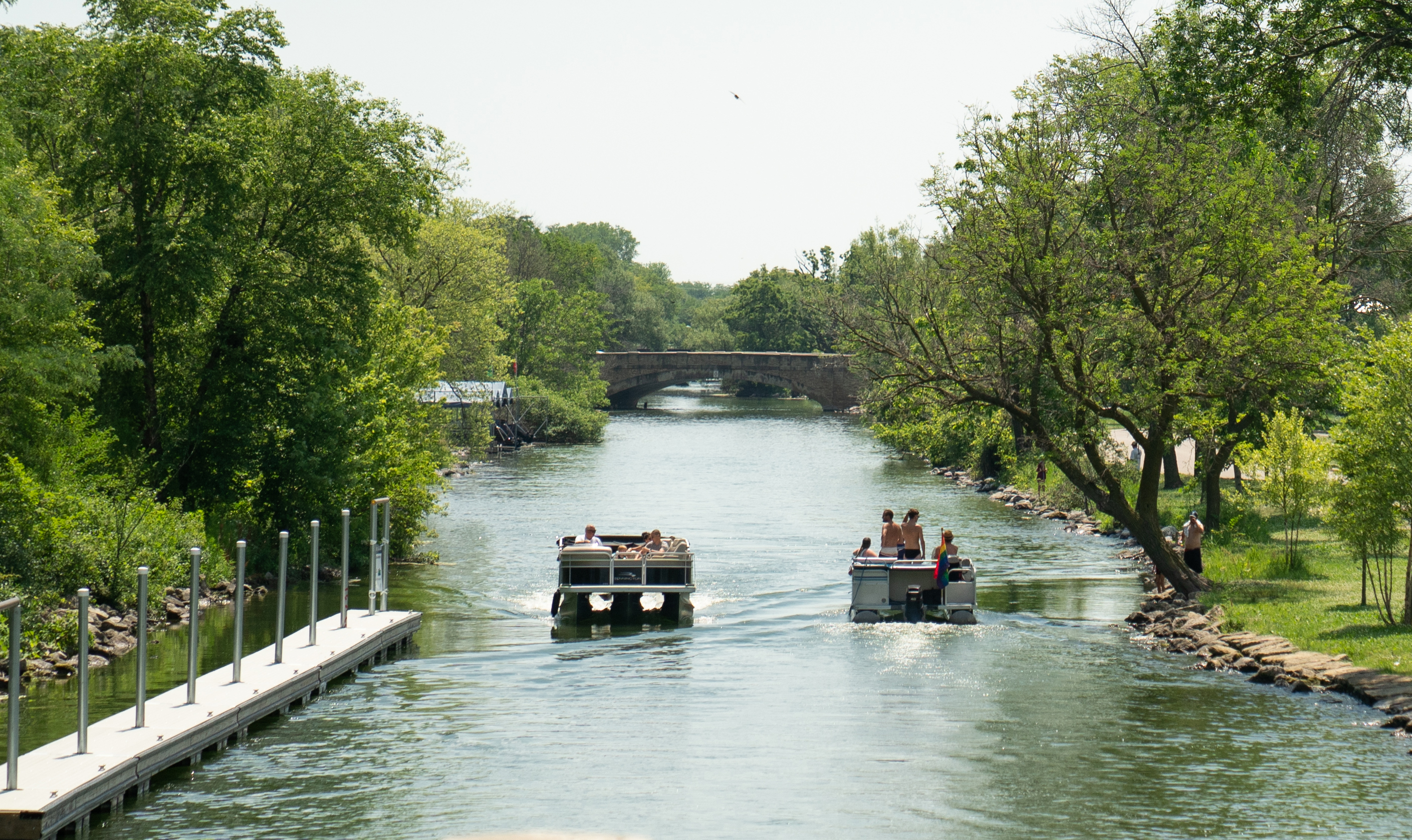 Two boats pass one another on the Yahara River