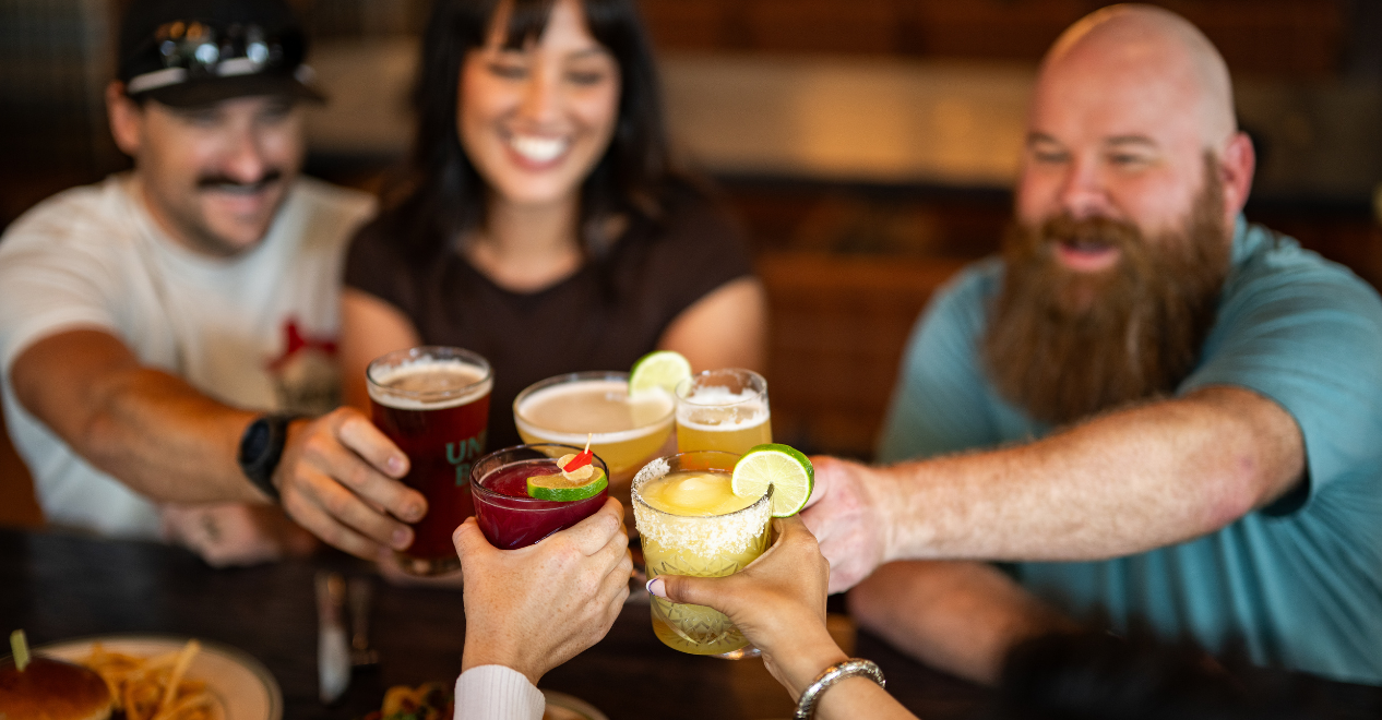 Group of friends celebrating with drinks