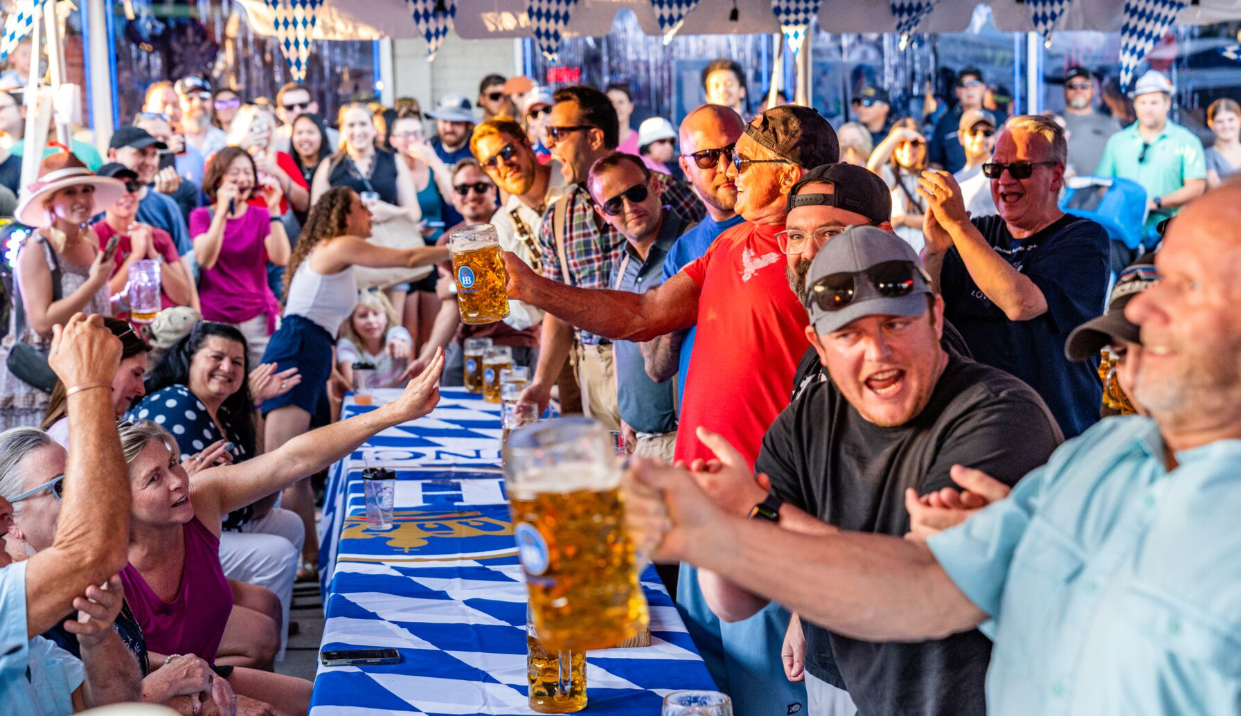 Men competing in a stein holding competition