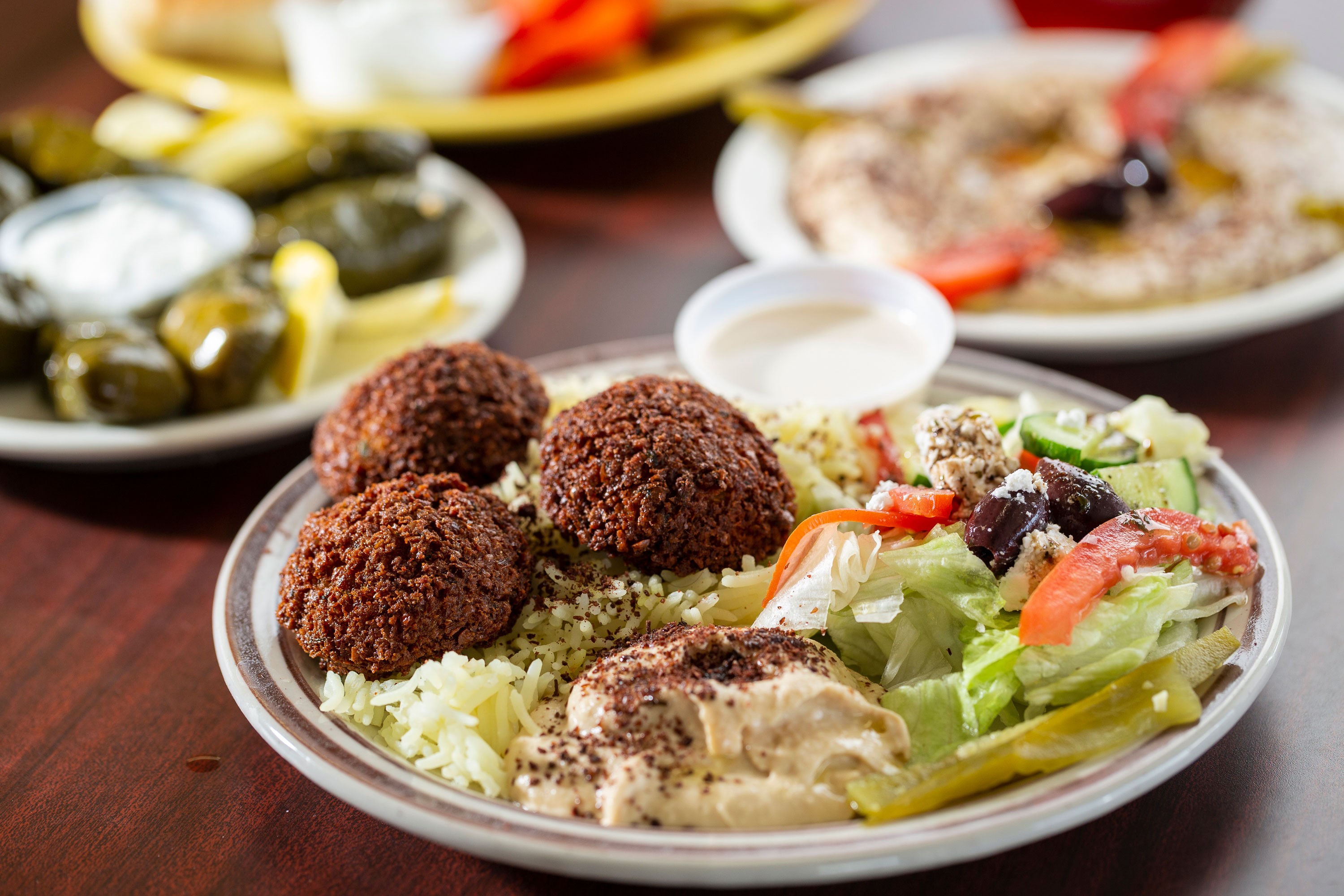 Falafel served with hummus, saffron rice, a Greek salad, and tahini sauce at Cafe Istanbul.
