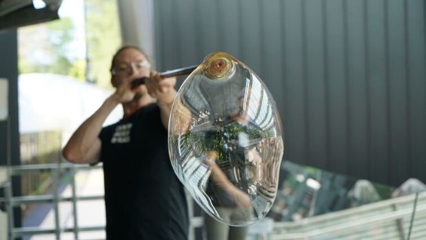 Man blowing glass at Corning Museum of Glass