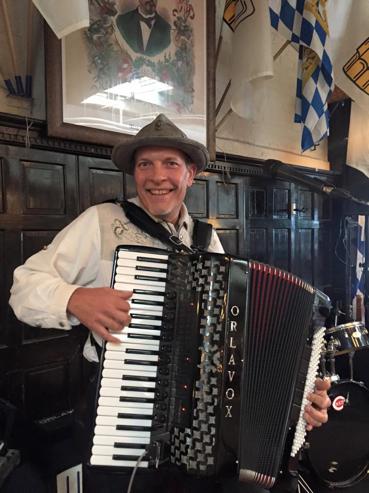 man playing accordion with smile on his face at hofbrauhaus in newport ky