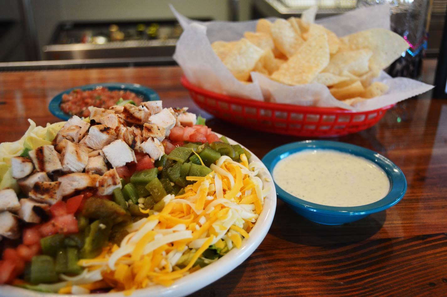 chuys florence ky creamy jalapeno dip, chips, plate of mexican food showcased on a bar