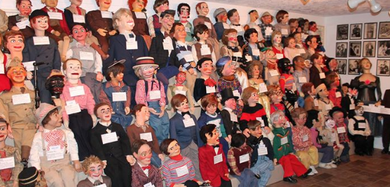 A wall of ventriloquist dummies at Vent Haven Museum