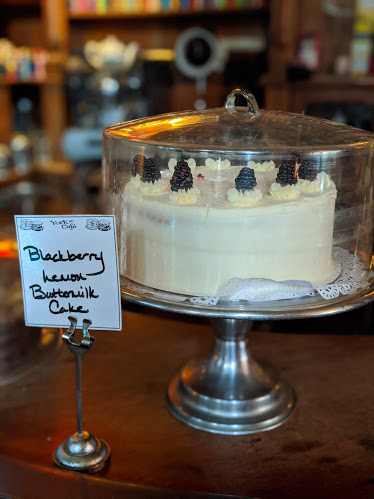 photo of a cake on a cake stand with a sign that says blueberry lemon buttermilk cake at york street cafe in newport ky