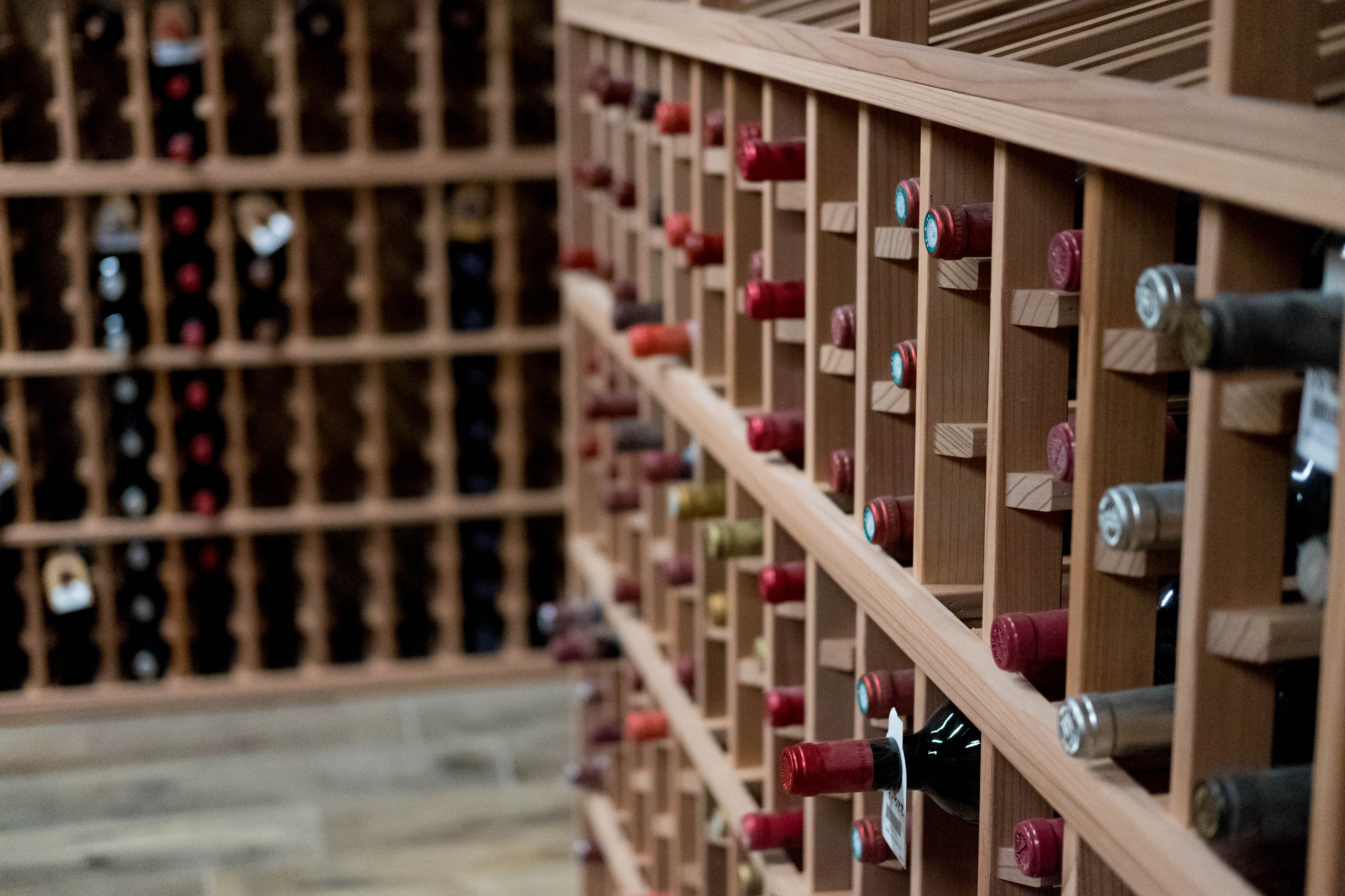 a large amount of wine bottles stored in wine racks