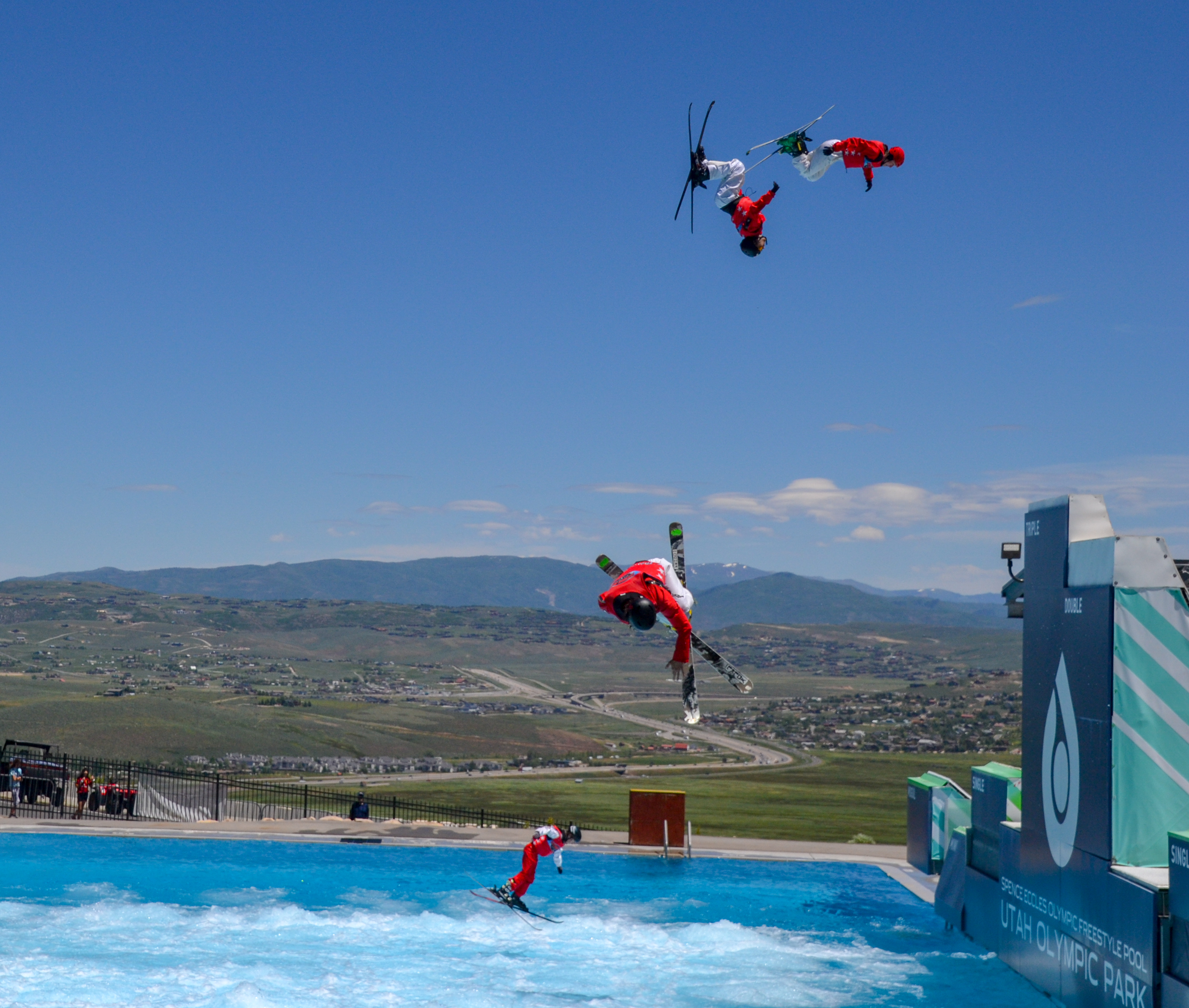 Freestyle Skiers jumping into a pool
