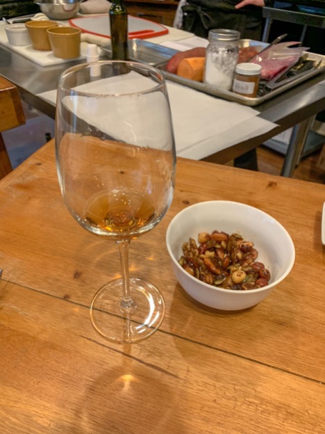 Glass of wine and bowl of nuts