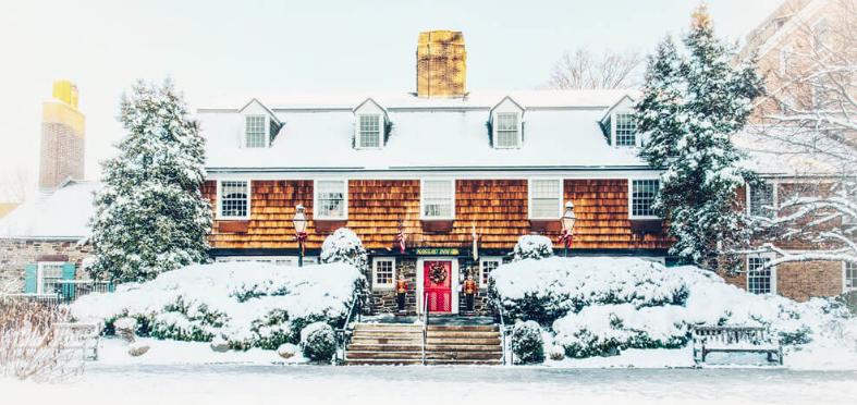 A watercolor painting of the Nassau Inn covered in snow