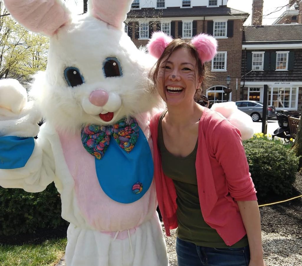 A woman poses with the Easter Bunny