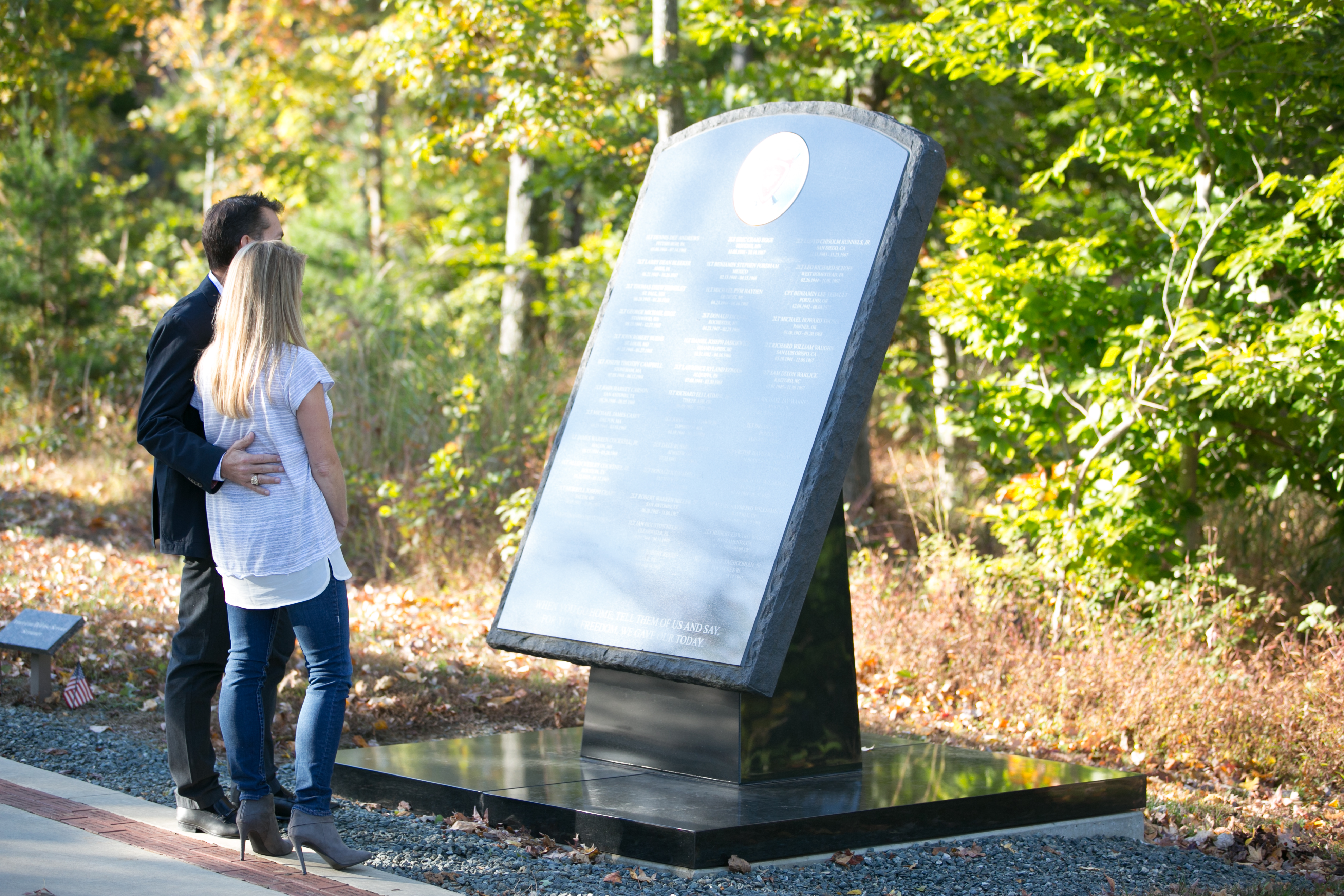 couple looking at an outdoor plaque at the  National Museum of the Marine Corps