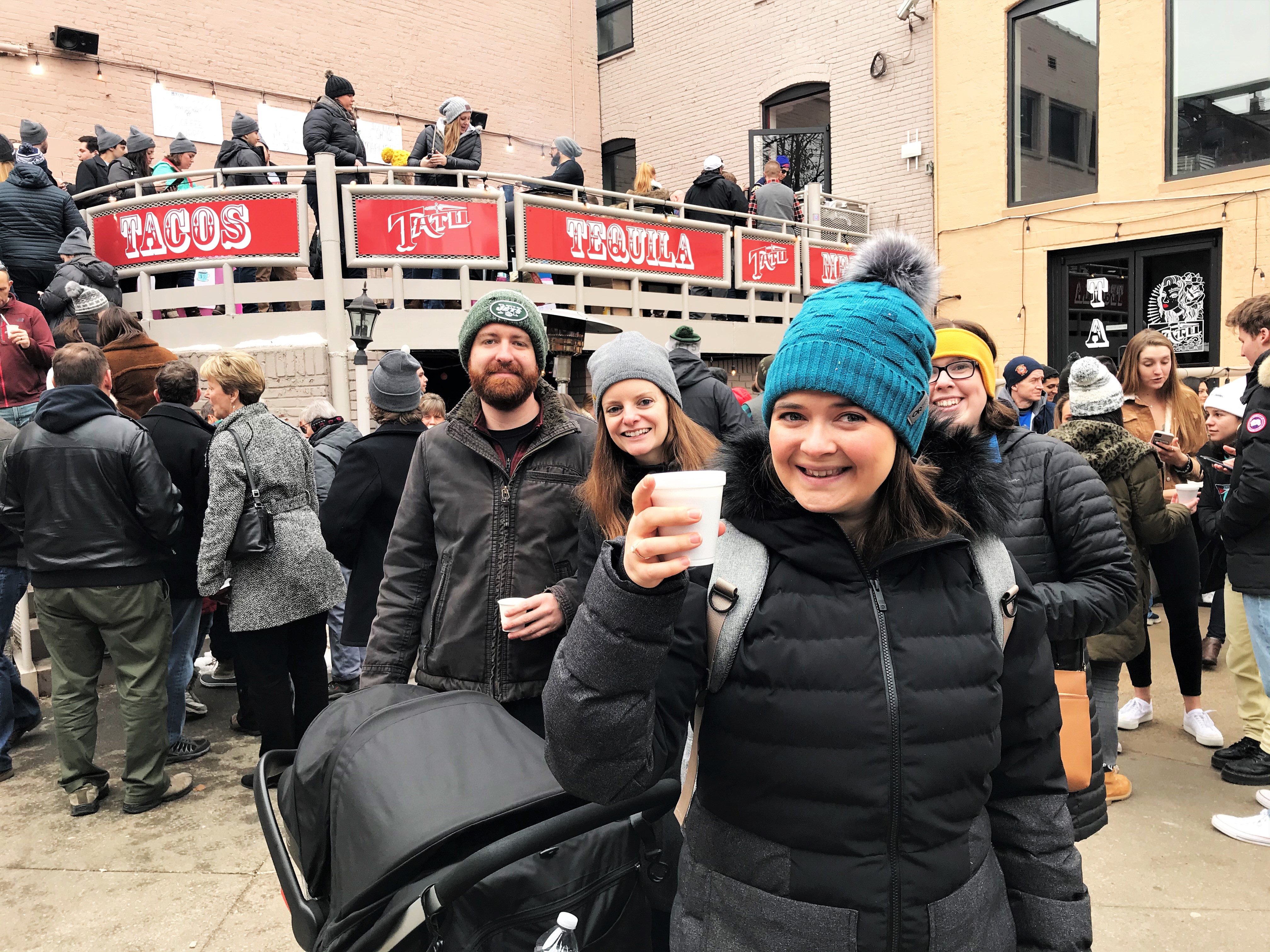 Girl posing in front of Tatu with crowd behind her