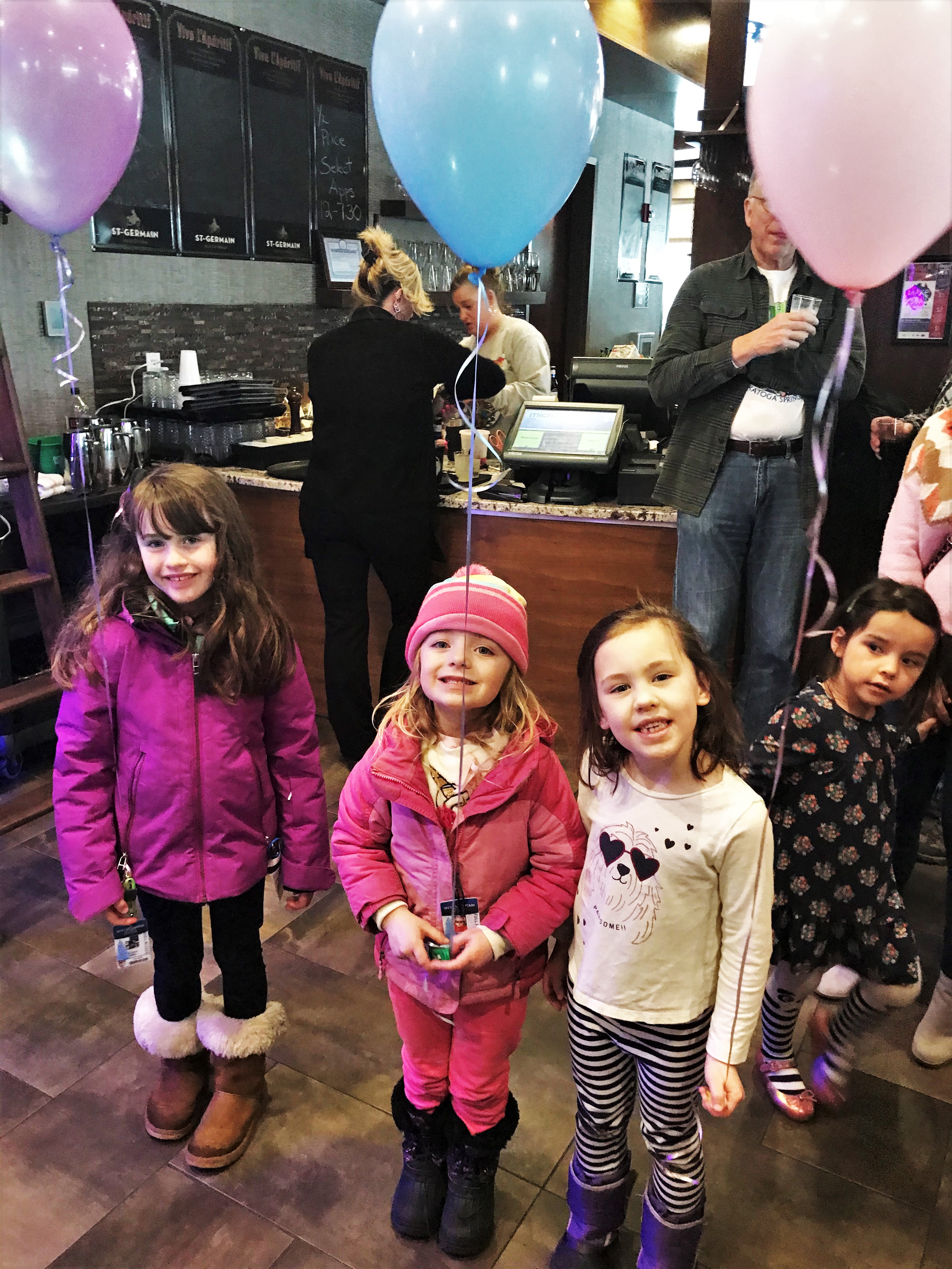 Three little girls with balloons