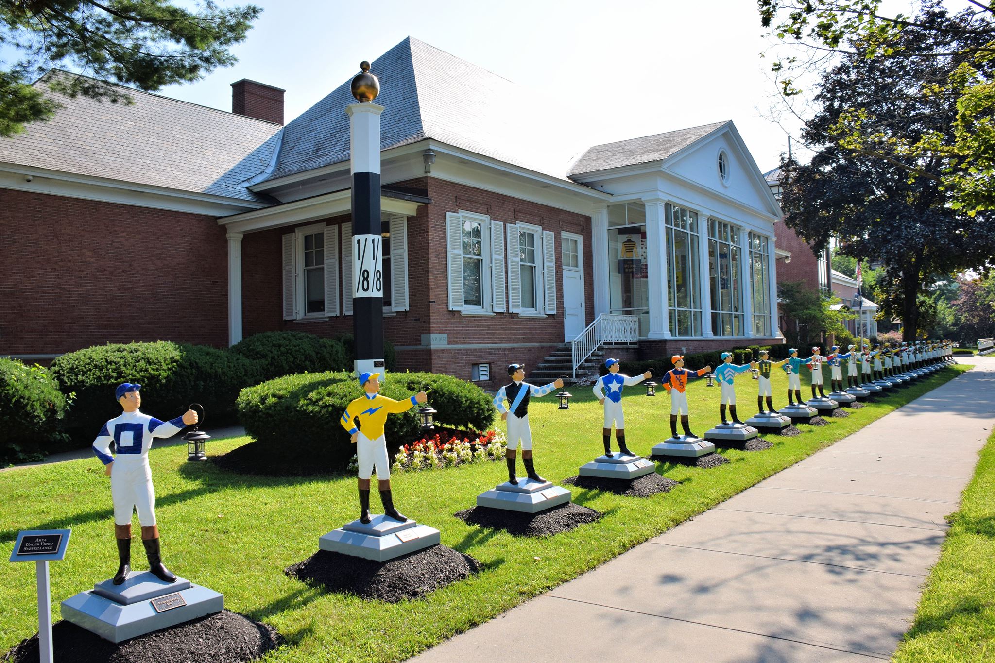 Row of lawn jockies in front of the National Museum of Racing