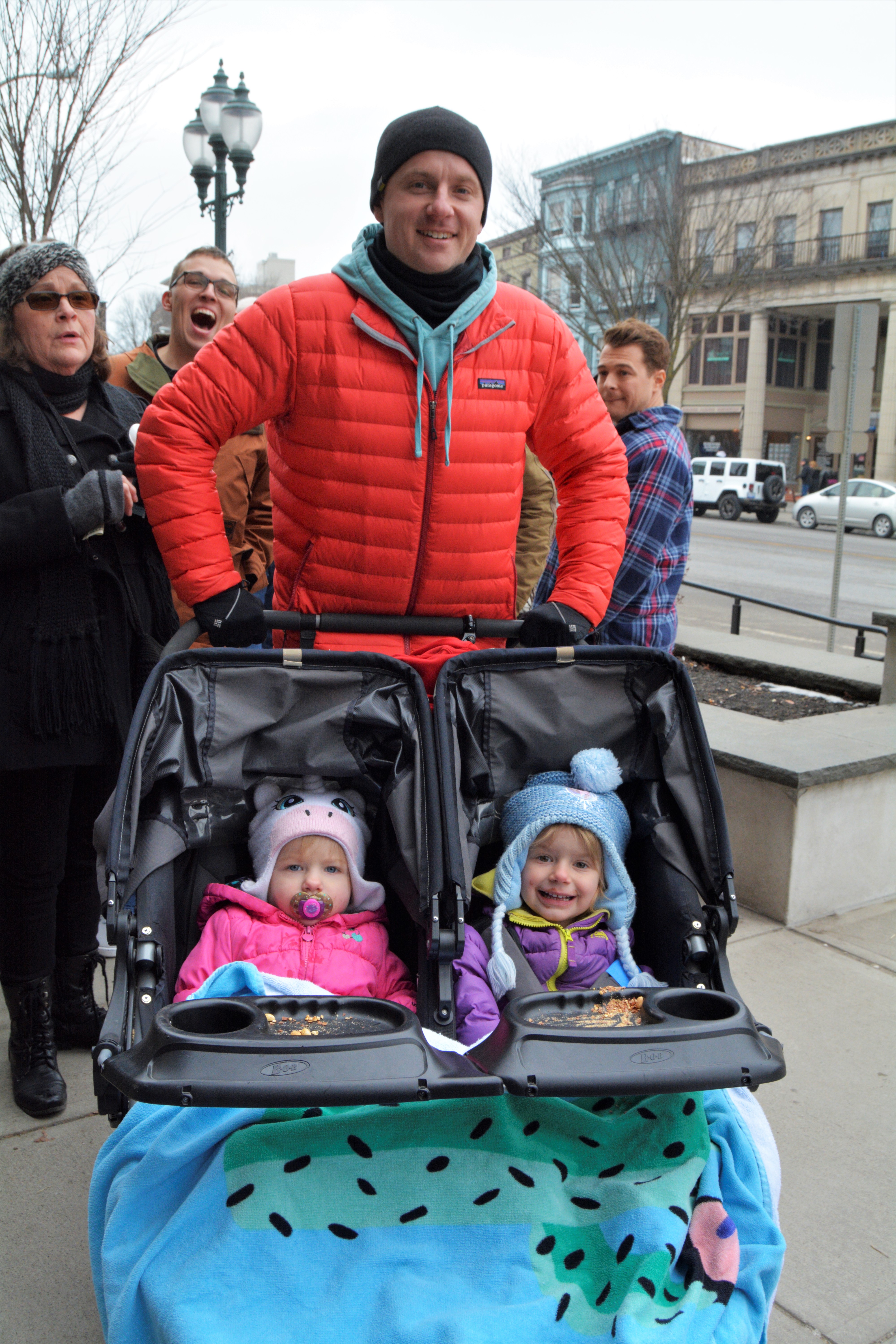 Father with two kids in jogging stroller