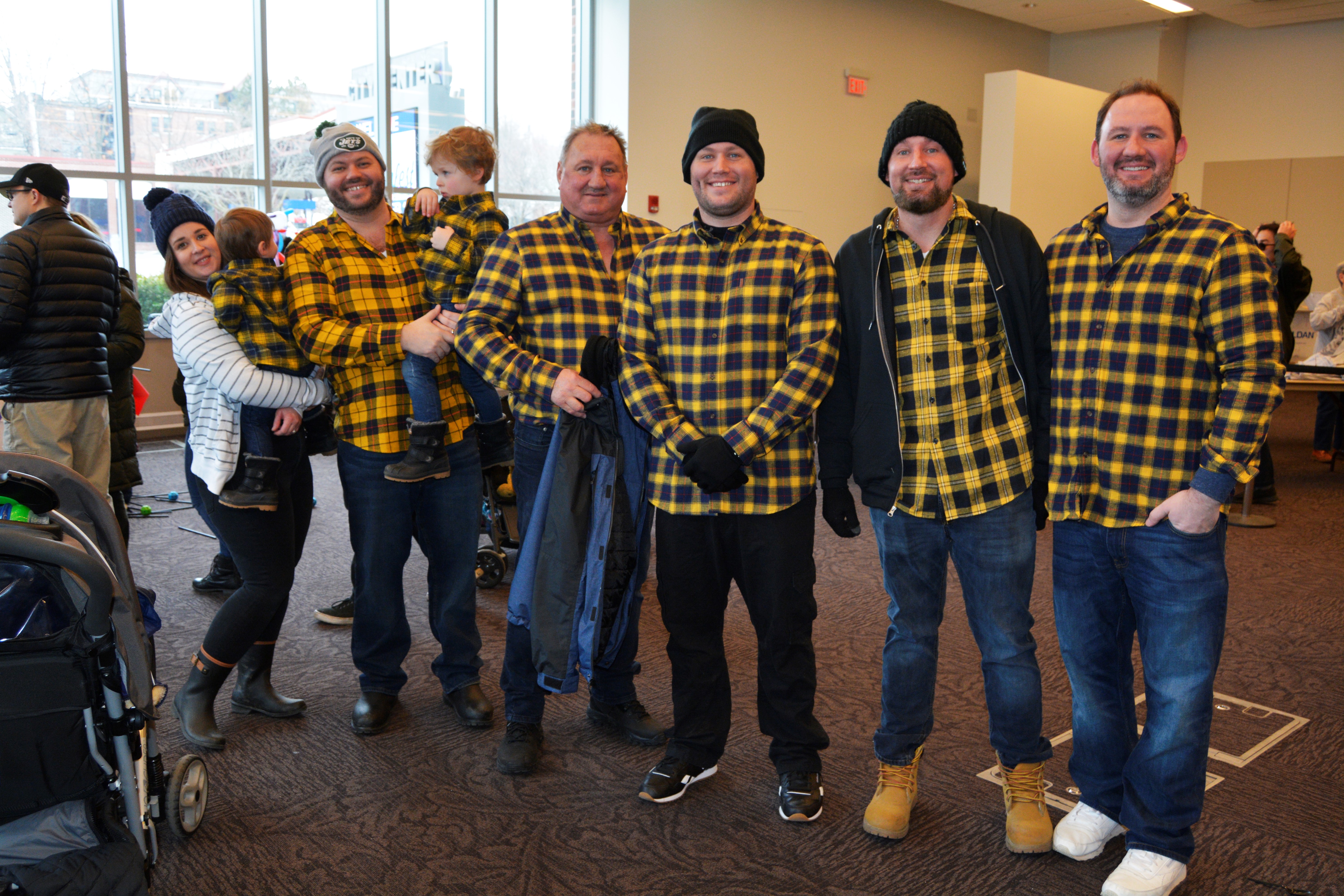 Group of 5 men and 2 boys dressed in yellow plaid
