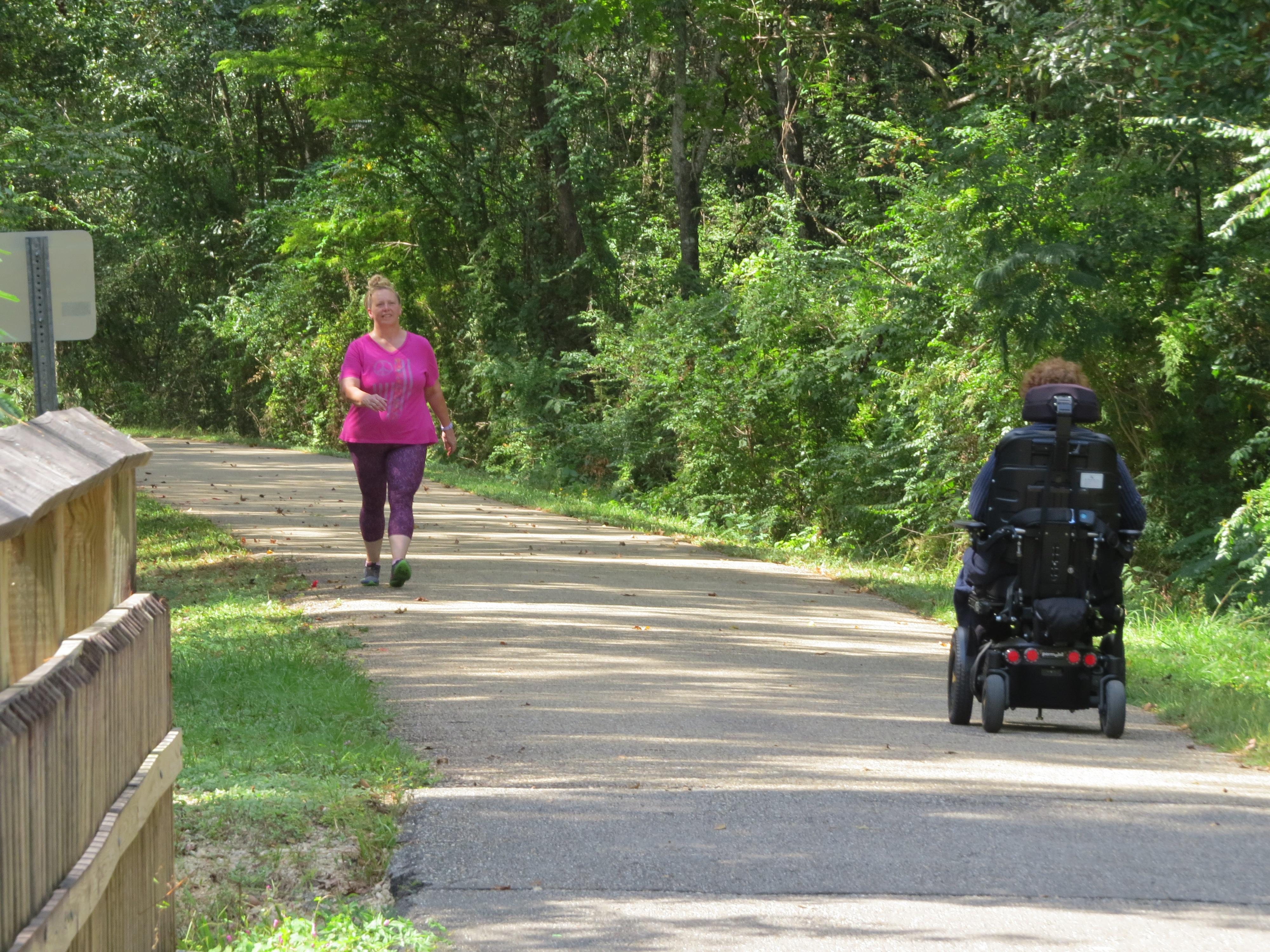 A person using a wheelchair on the Tammany Trace trail