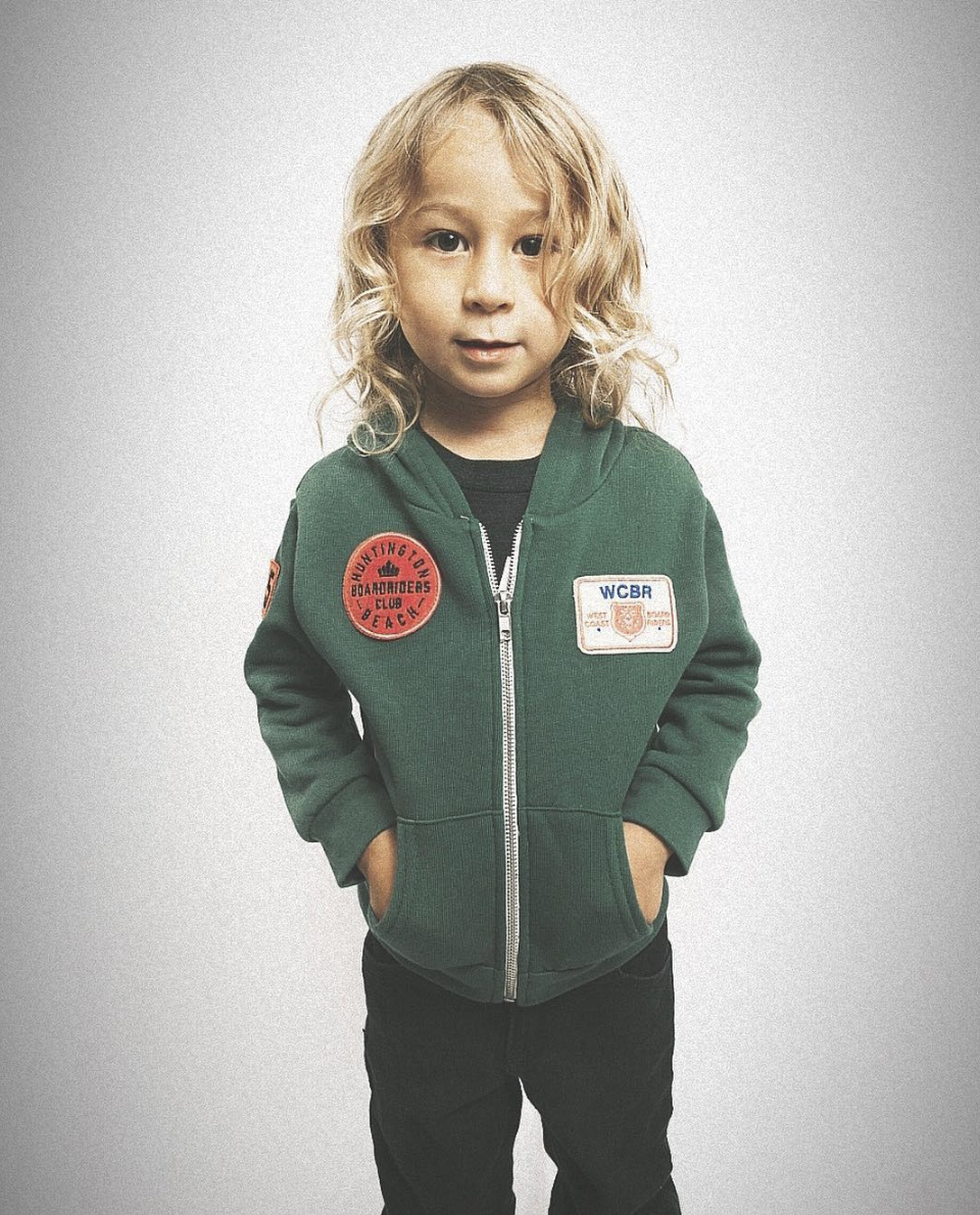 Young child wearing Sport of Kings Forever Young Surf Brand