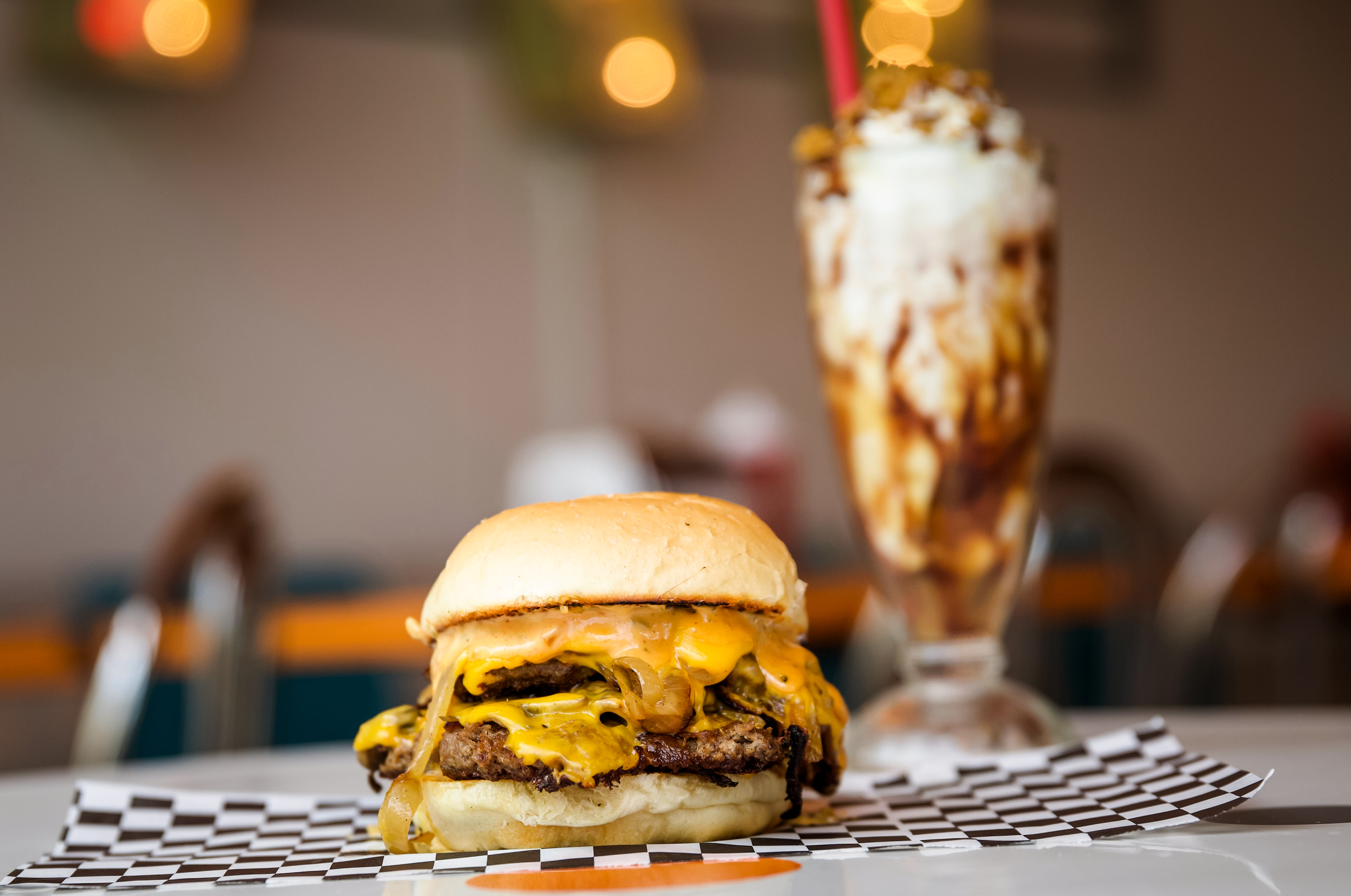 Cheeseburger on a tray with a tall milkshake at Shake Shake Shake in Tacoma.