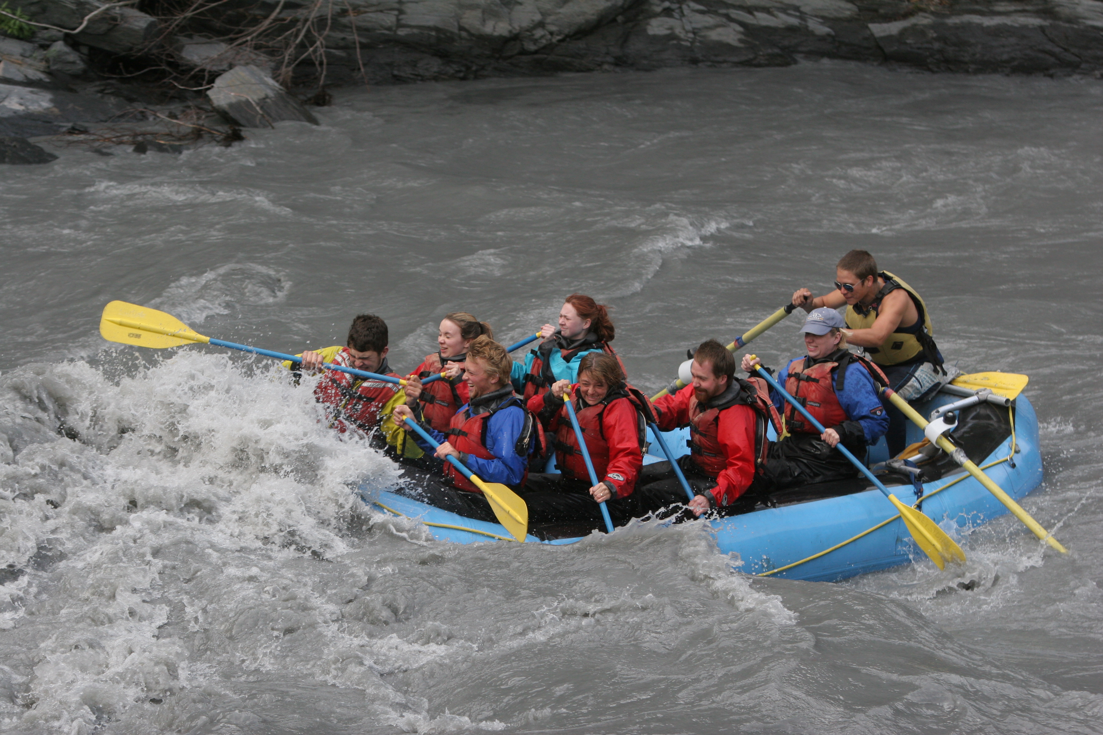 People in a river raft on a river in Keystone Canyon