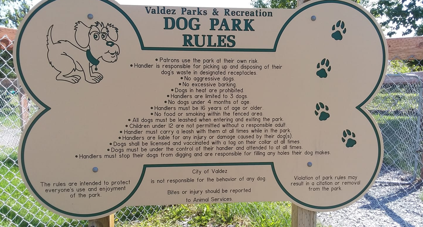 a set of rules for a dog park printed on a sign