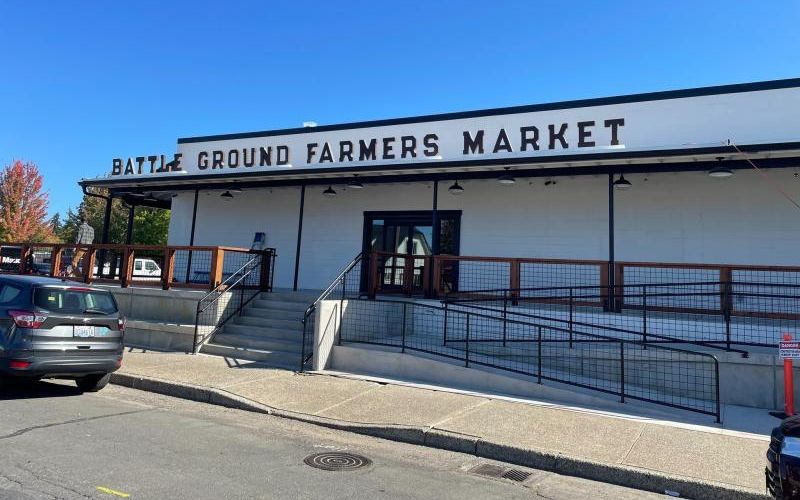 Exterior of the Battle Ground Farmers Market building on a clear blue-sky day