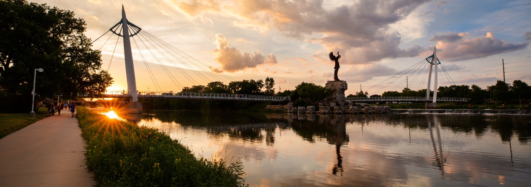 Wide angle shot of the Keeper of the Plains at dusk from the south bank of the river in Wichita