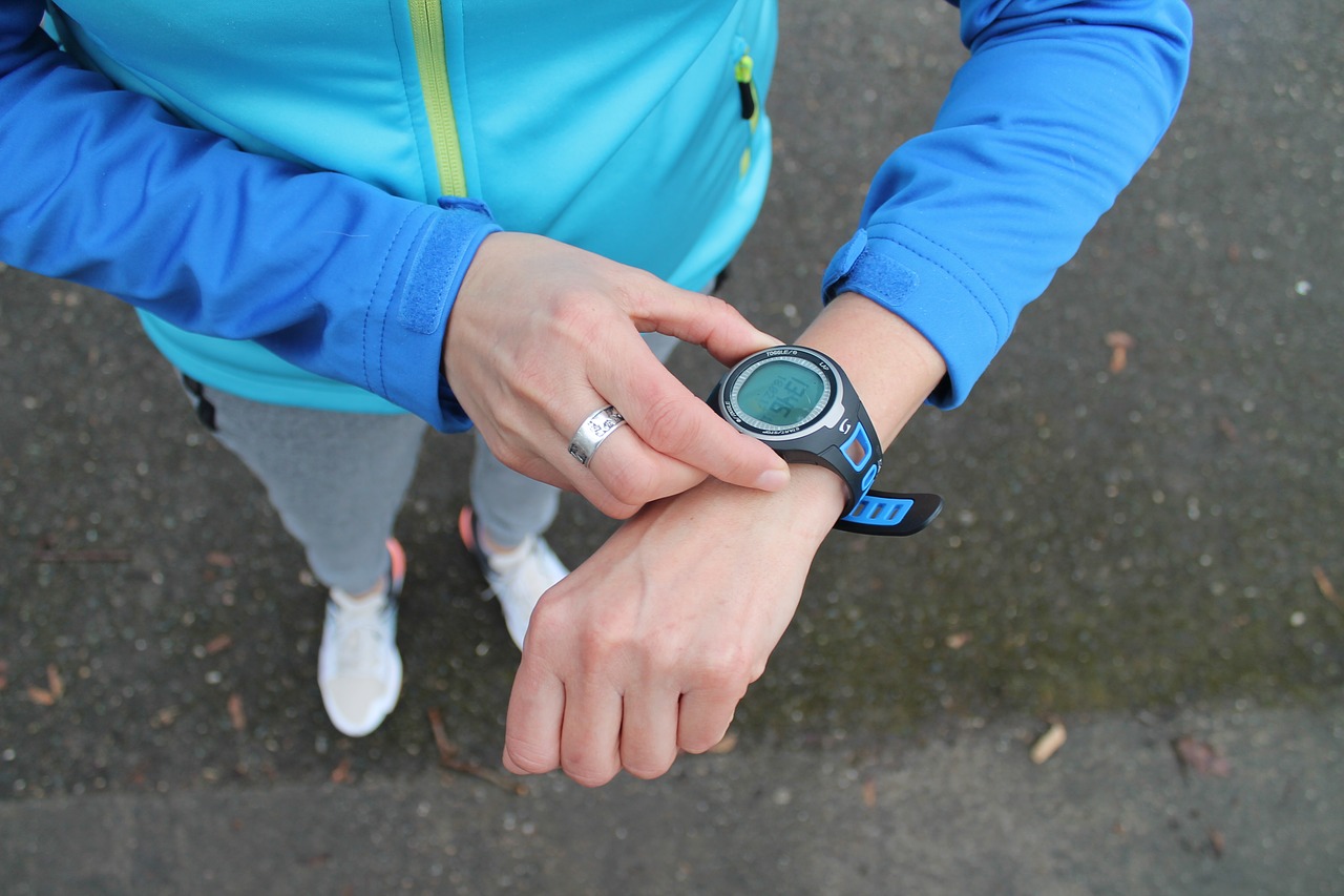 A runner stops her watch to check her time after a Wichita marathon
