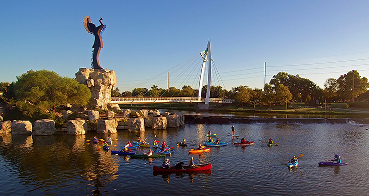 Seasons - kayaks on the Arkansas River in downtown Wichita underneath the keeper of the plains statue