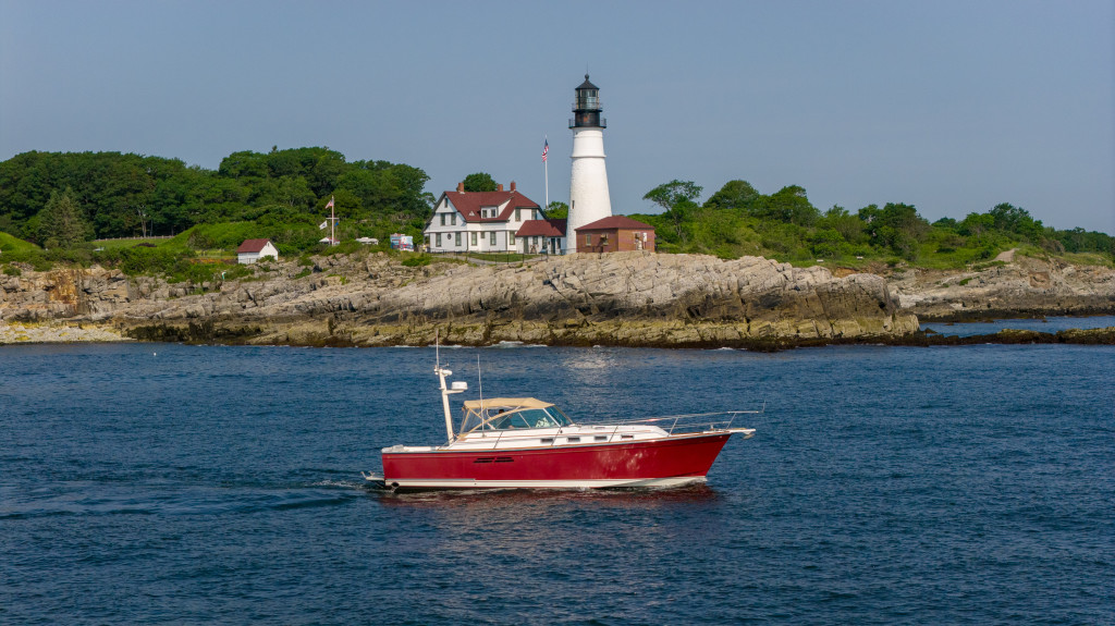 Boat by Portland Head Light. Photo Credit: Peter G. Morneau