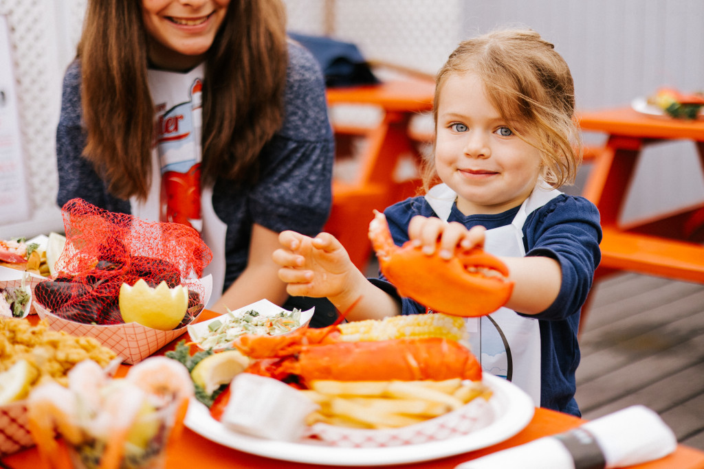 Kid eating lobster. Photo Credit: Jamie Mercurio Photography