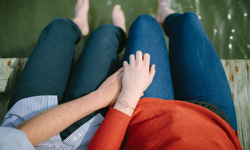 Couple on dock with bracelet. Photo Credit: Jamie Mercurio Photography