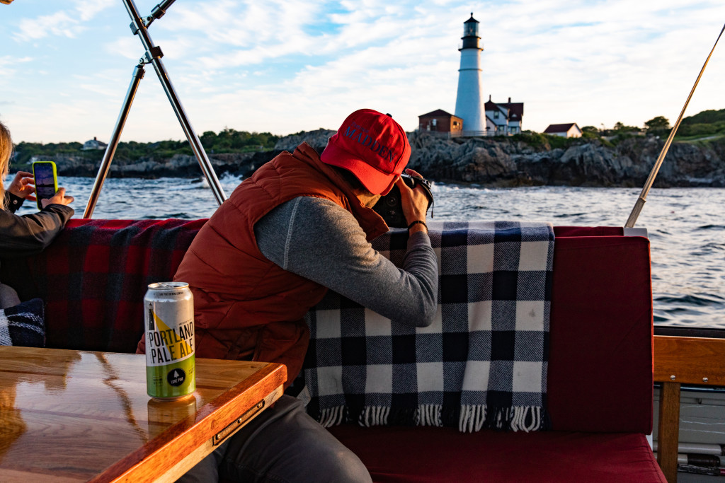 Photographing Portland Head Light on Boat. Photo Credit: Casco Bay Custom Charters