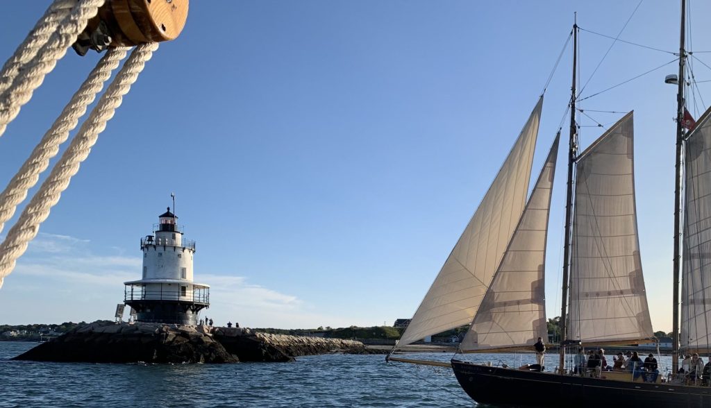 Sailboat by Lighthouse. Photo Credit: Portland Schooner Co.