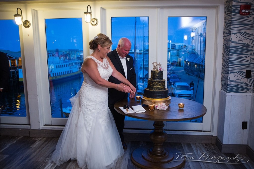 Wedding Couple Cutting Cake. Photo Credit: Focus Photography