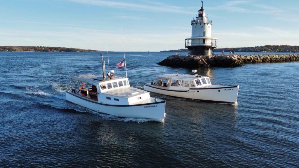 Boats Cruising Past Lighthouse. Photo Credit: Casco Bay Custom Charters