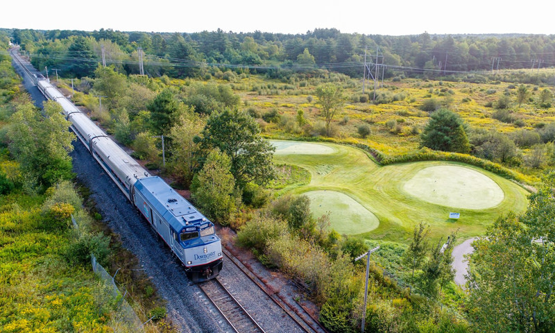 Train by Golf Course. Photo Credit: Amtrak Downeaster