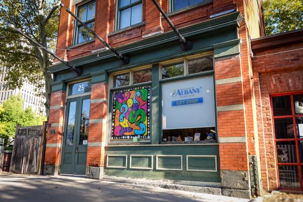 Outdoors of the Discover Albany Visitors Center with All Hallow E'en Art Path artwork