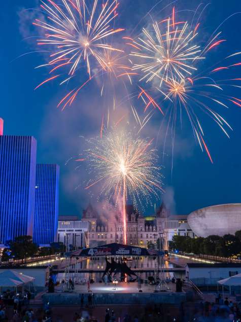 Fireworks in on a dark blue sky at the Empire State Plaza in Albany, New York.