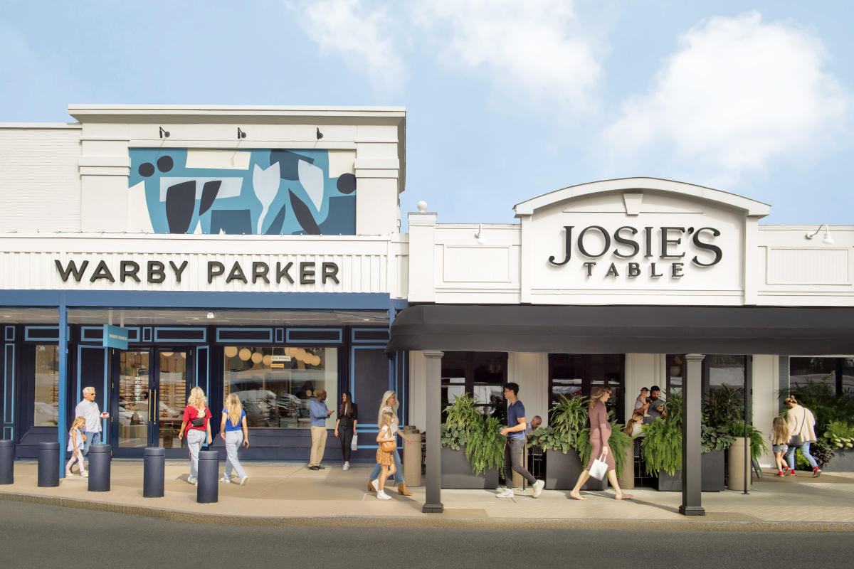 Shoppers walking past Warby Parker and Josie's Table at Stuyvesant Plaza in Albany, New York