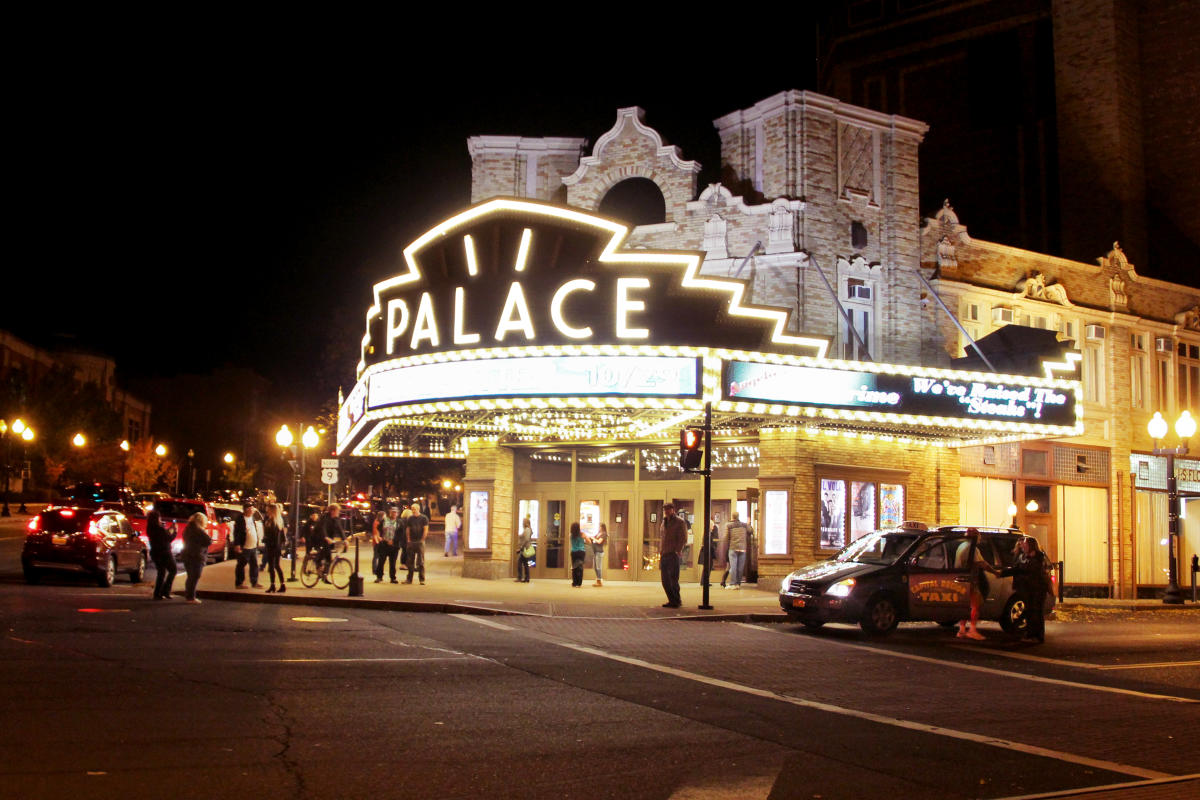 Palace Theater in Downtown Albany, New York at nighttime with people waiting outside.