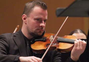 A symphony musician plays the violin at the Alaska Center for the Performing Arts.