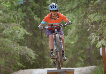 A mountain biker takes a jump on the Hillside in Anchorage.