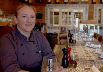 Chef Nancy Alip behind the bar at Jens Restaurant